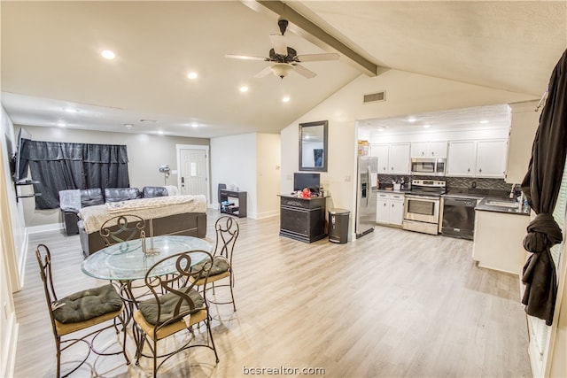 dining area with vaulted ceiling with beams, ceiling fan, light wood-type flooring, and sink