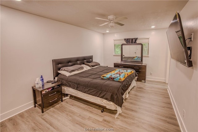 bedroom with ceiling fan and light hardwood / wood-style floors