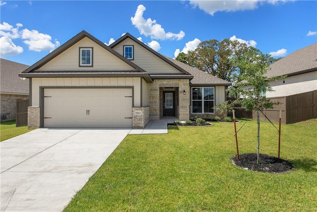 craftsman-style house featuring a front yard and a garage