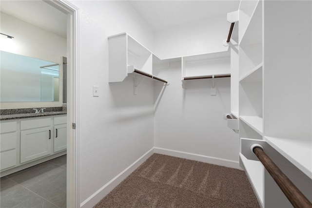 spacious closet with dark carpet