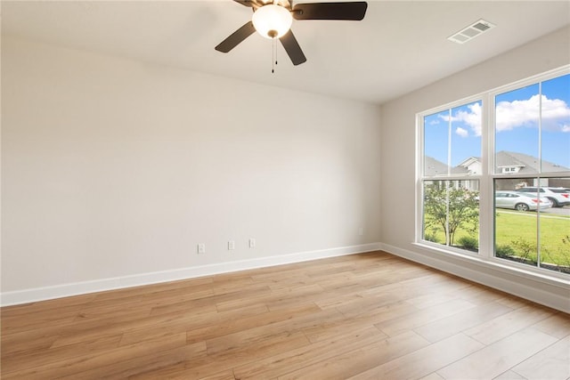 unfurnished room featuring light hardwood / wood-style floors and ceiling fan