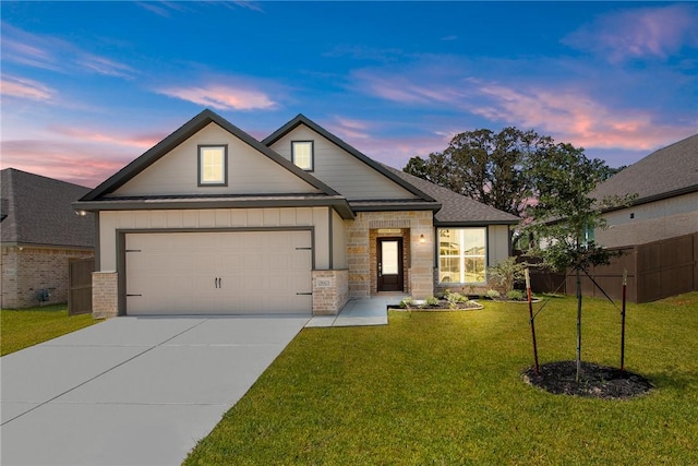 view of front of property featuring a yard and a garage