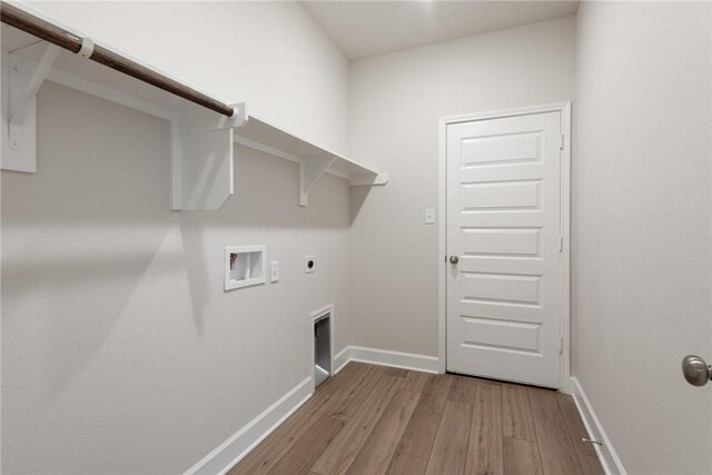 laundry area with electric dryer hookup, washer hookup, and light wood-type flooring