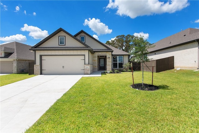 craftsman inspired home featuring a garage and a front yard