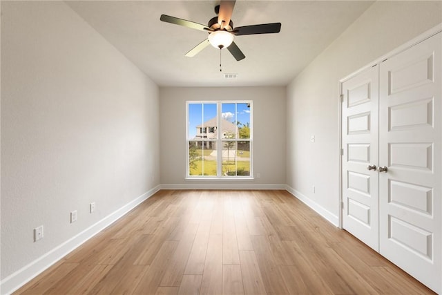 empty room featuring ceiling fan and light hardwood / wood-style floors