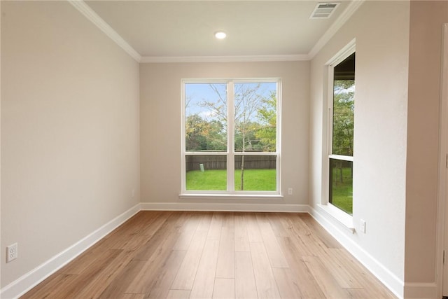 empty room featuring crown molding and light hardwood / wood-style floors