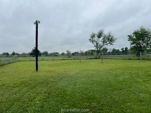 view of yard with a rural view and fence