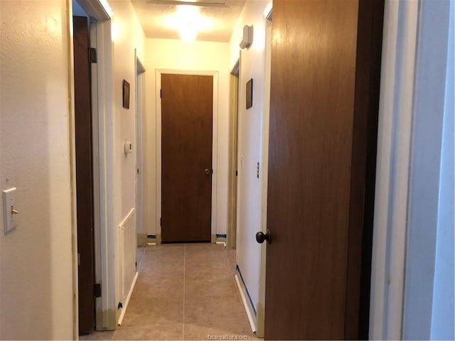 corridor featuring light tile patterned floors