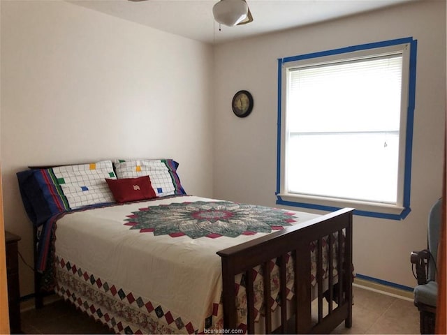 bedroom with tile patterned flooring and baseboards