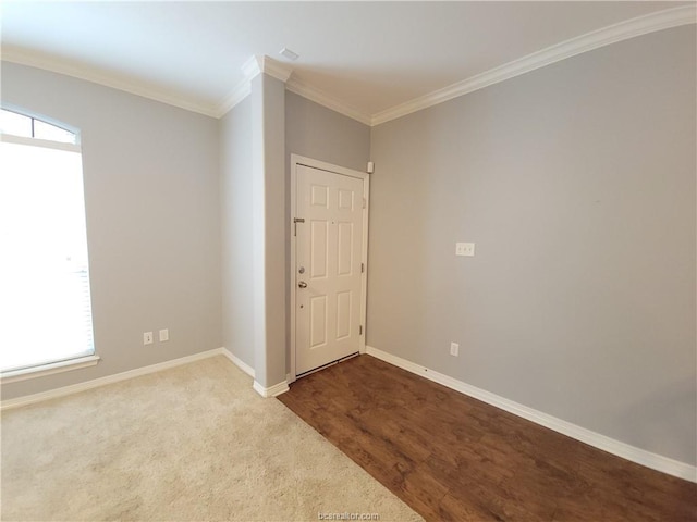 empty room with crown molding and hardwood / wood-style flooring