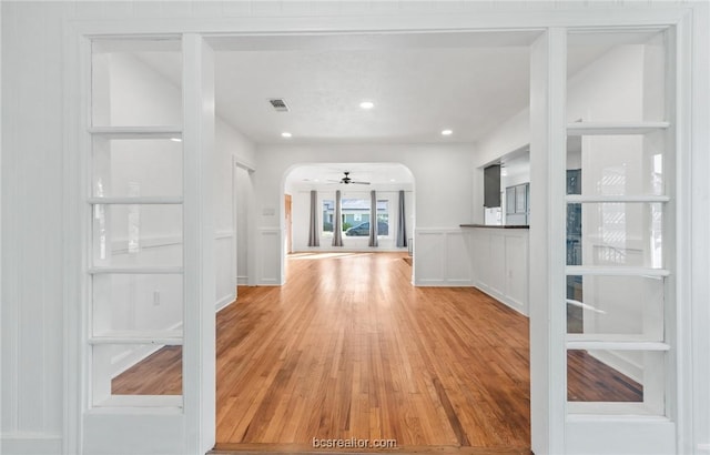 unfurnished living room featuring ceiling fan and hardwood / wood-style floors