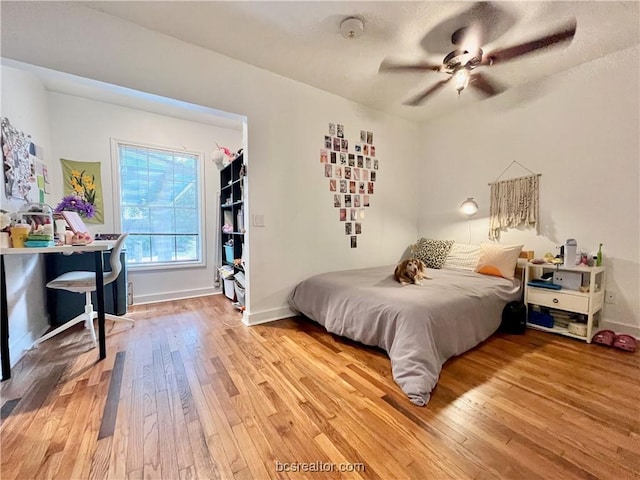 bedroom with hardwood / wood-style flooring and ceiling fan