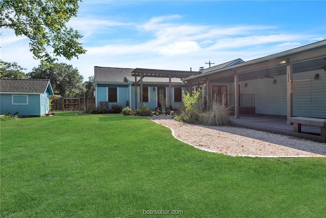 back of property with a storage shed, a pergola, a yard, and a patio