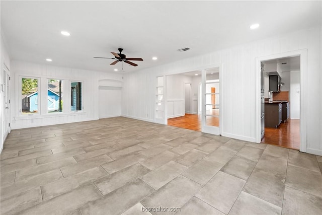 unfurnished living room featuring ceiling fan and light hardwood / wood-style floors