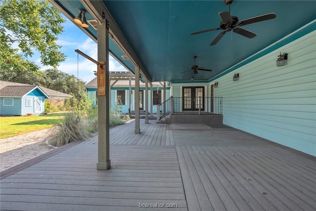 deck with french doors, ceiling fan, and a storage shed