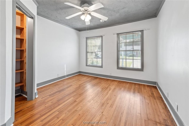 unfurnished room with ceiling fan, light hardwood / wood-style flooring, crown molding, and a textured ceiling