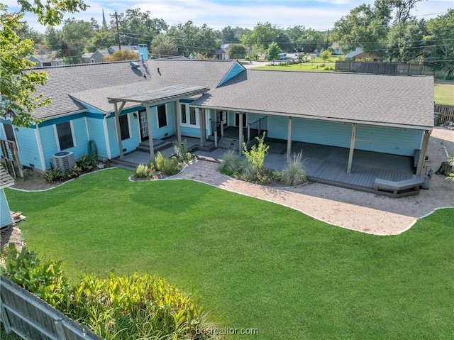 rear view of house featuring a lawn, central AC unit, and a patio area