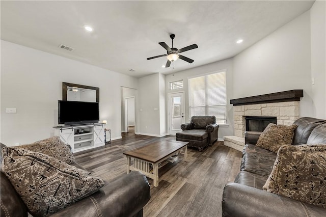 living room with ceiling fan, dark hardwood / wood-style flooring, and a fireplace