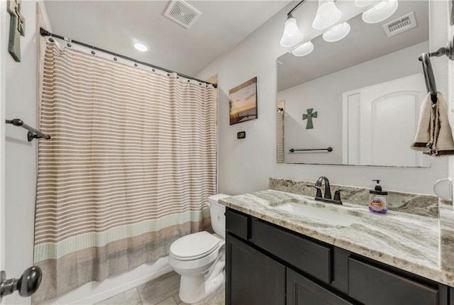 full bathroom with tile patterned flooring, shower / bath combo, vanity, and toilet