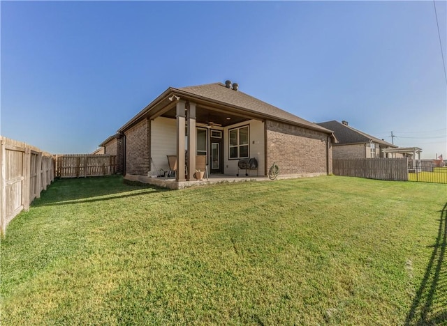 back of house with a lawn, a patio area, and ceiling fan