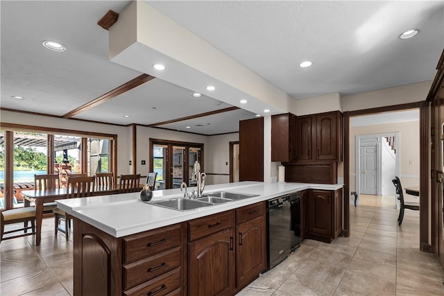 kitchen featuring a peninsula, a sink, black dishwasher, light countertops, and recessed lighting