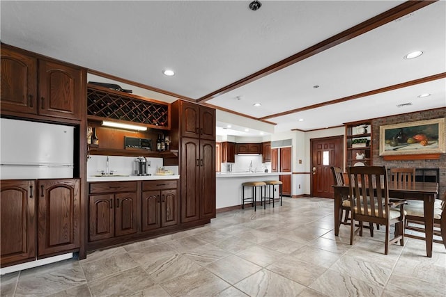 interior space featuring a sink, open shelves, visible vents, light countertops, and recessed lighting