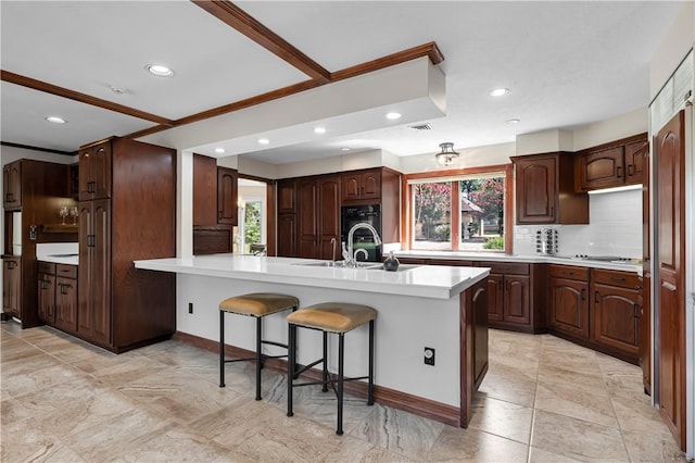kitchen featuring recessed lighting, a kitchen bar, a peninsula, decorative backsplash, and light countertops