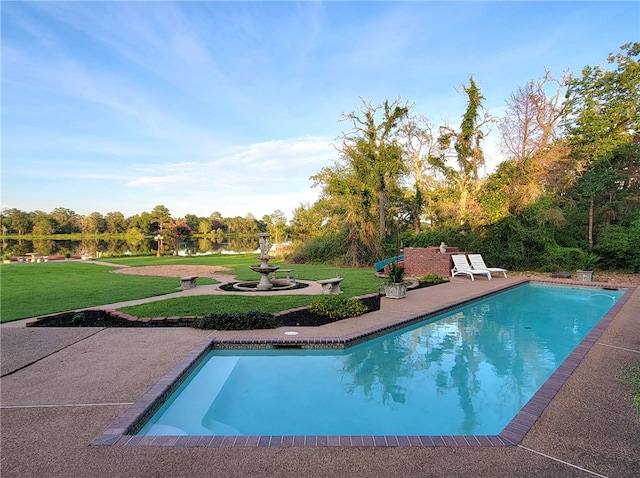 pool featuring a patio and a lawn