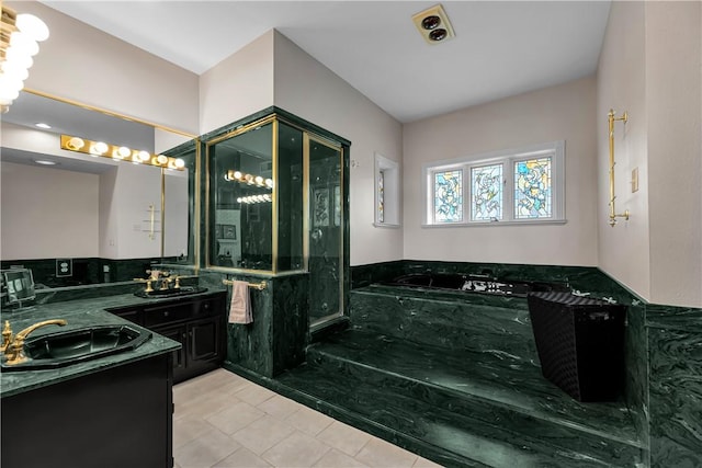 full bath featuring vanity, a garden tub, a shower stall, and tile patterned floors