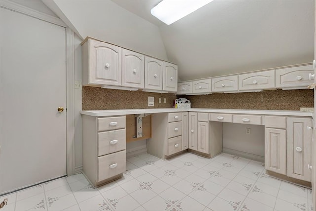 unfurnished office featuring built in study area and lofted ceiling