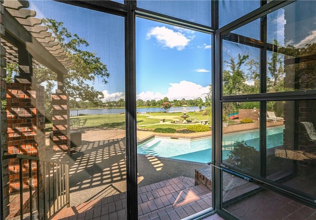 exterior space featuring expansive windows and a water view
