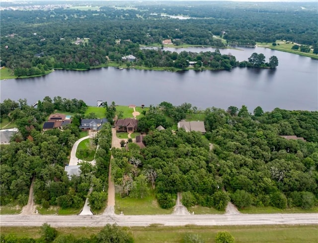 aerial view featuring a wooded view and a water view