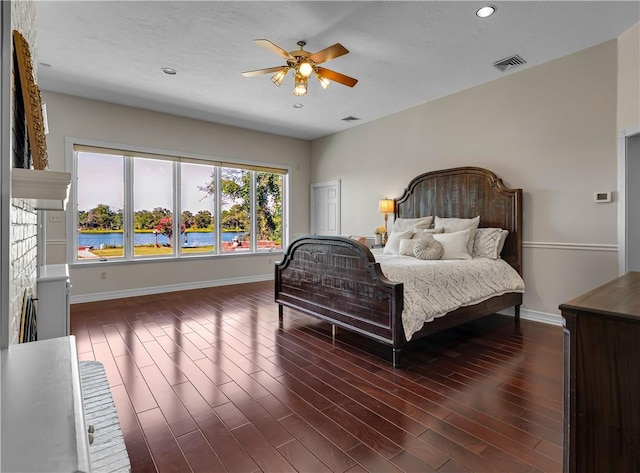 bedroom featuring recessed lighting, visible vents, baseboards, and dark wood-style floors
