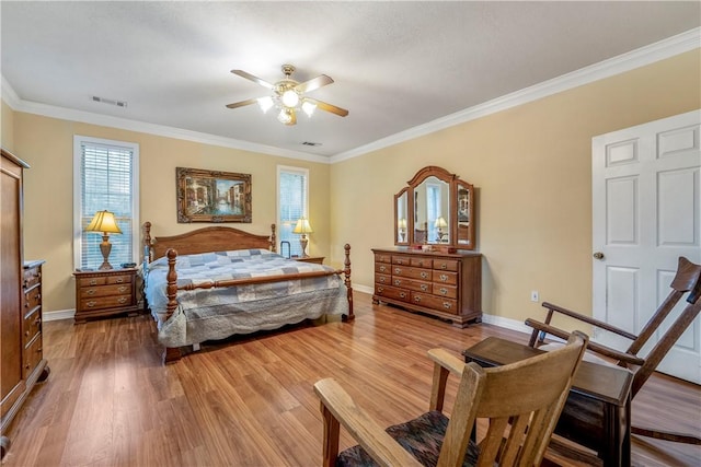 bedroom with ceiling fan, wood-type flooring, and crown molding