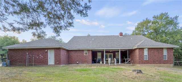 back of property featuring a yard, ceiling fan, and a patio area