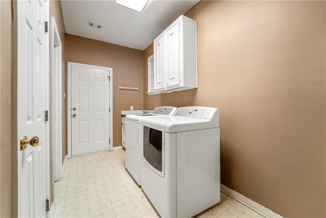 laundry area with cabinets and washing machine and clothes dryer