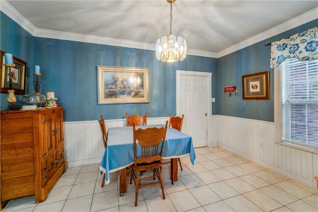 dining area with light tile patterned floors, a notable chandelier, and ornamental molding