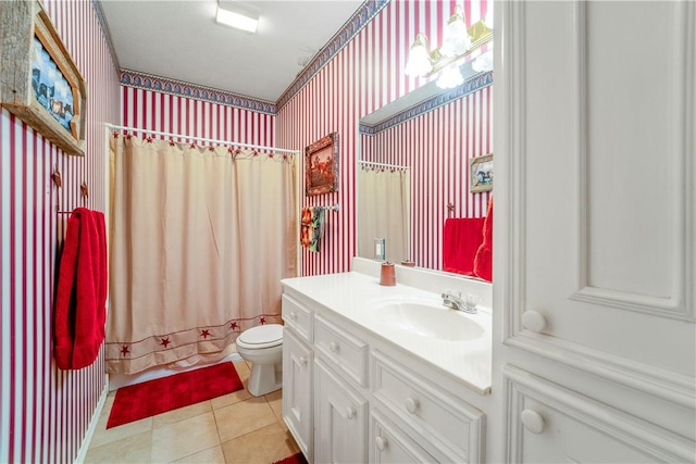 full bathroom featuring tile patterned flooring, vanity, toilet, and shower / tub combo with curtain