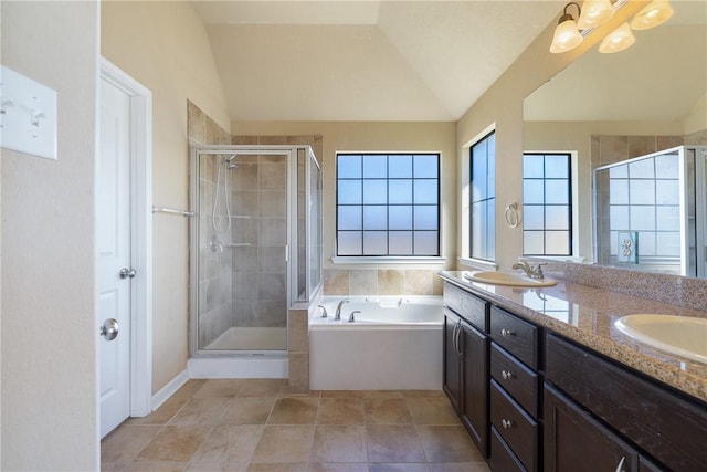 bathroom with independent shower and bath, tile patterned flooring, vaulted ceiling, and vanity