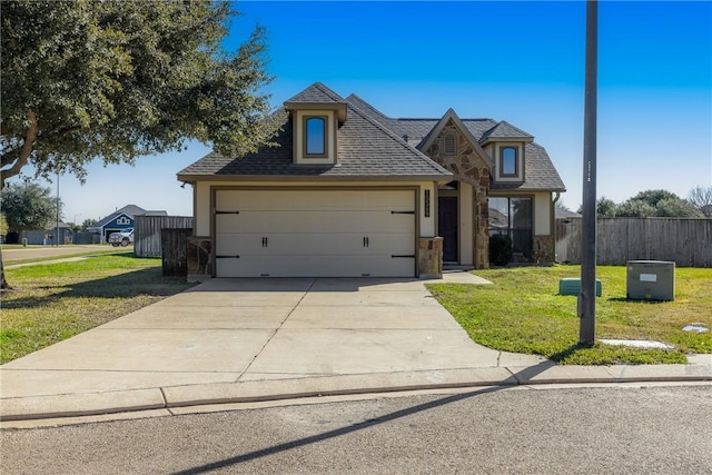 view of front of home featuring a front yard and a garage