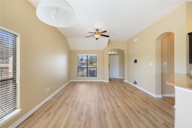 unfurnished living room with ceiling fan, light hardwood / wood-style flooring, and vaulted ceiling