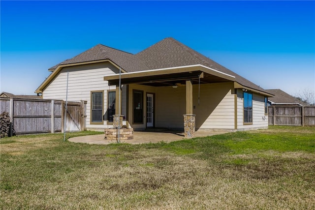 back of house with a patio area and a yard