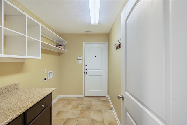 laundry area featuring washer hookup, hookup for an electric dryer, and a textured ceiling