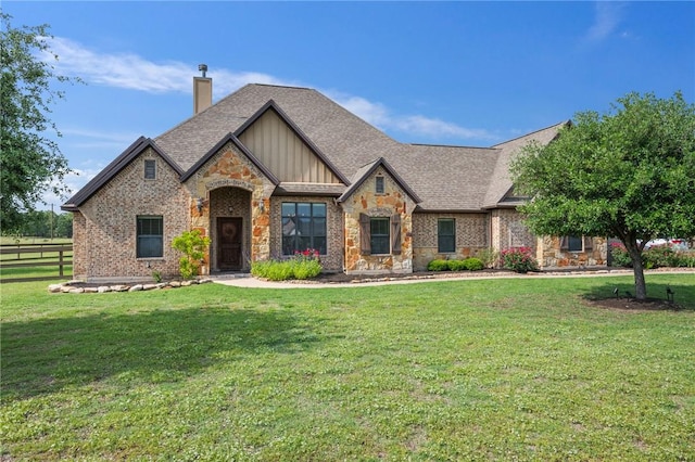 5398 Prairie Dawn Trl, College Station, TX 77845 - view of front of home featuring fence, a front yard, stone siding, a chimney, and board and batten siding