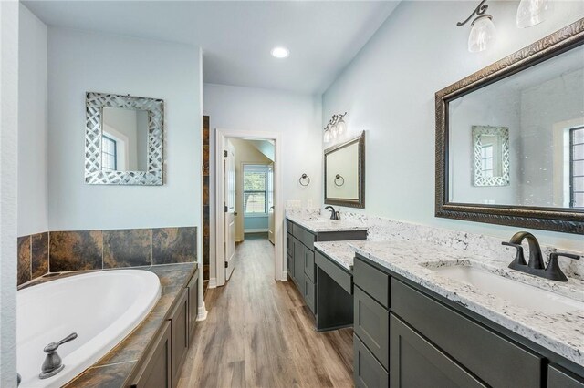 5398 Prairie Dawn Trl, College Station, TX 77845 - bathroom with a sink, recessed lighting, two vanities, wood finished floors, and a bath