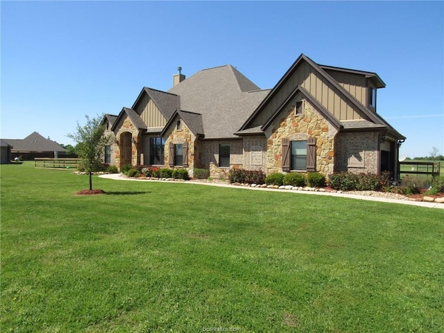 5398 Prairie Dawn Trl, College Station, TX 77845 - craftsman-style house featuring board and batten siding, a chimney, a front lawn, and stone siding