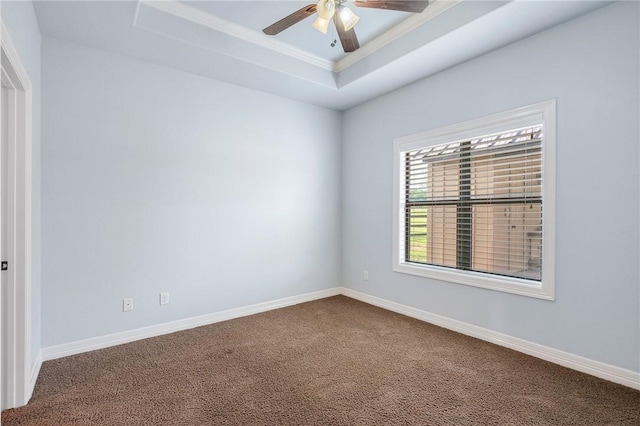 5398 Prairie Dawn Trl, College Station, TX 77845 - empty room featuring a ceiling fan, a raised ceiling, baseboards, dark colored carpet, and ornamental molding