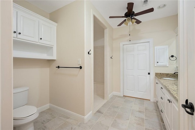 bathroom featuring vanity, toilet, and ceiling fan