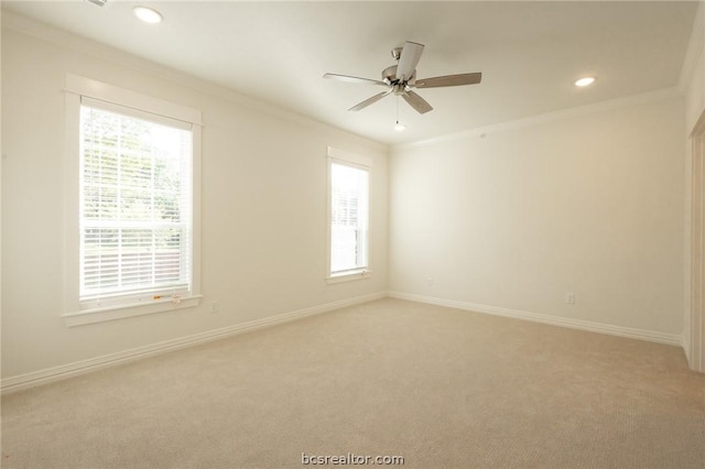 unfurnished room featuring ceiling fan, light colored carpet, and ornamental molding