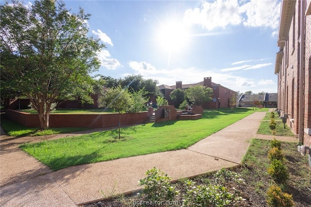 view of home's community with a lawn